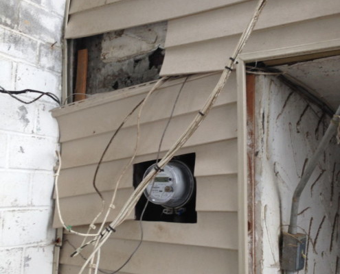 Loose siding led to water damage inside and unsafe wiring conditions